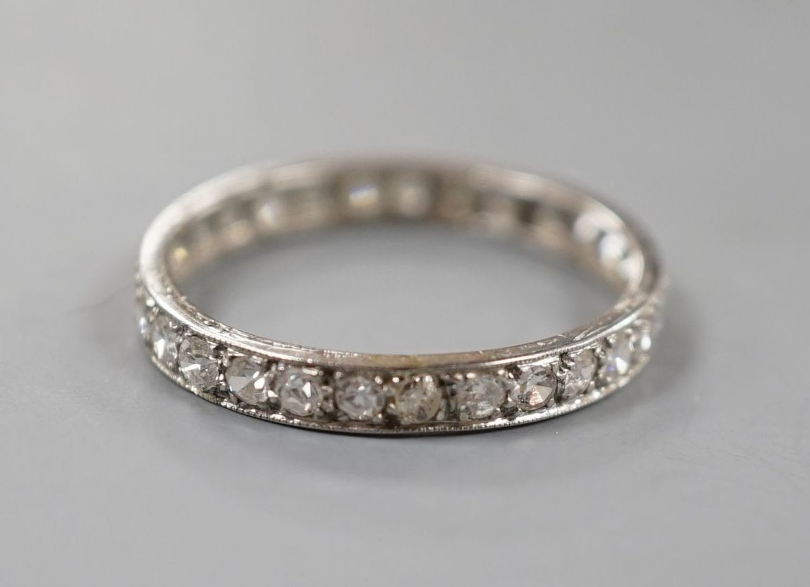 A white metal and diamond set full eternity ring, size Q, gross weight 2 grams.